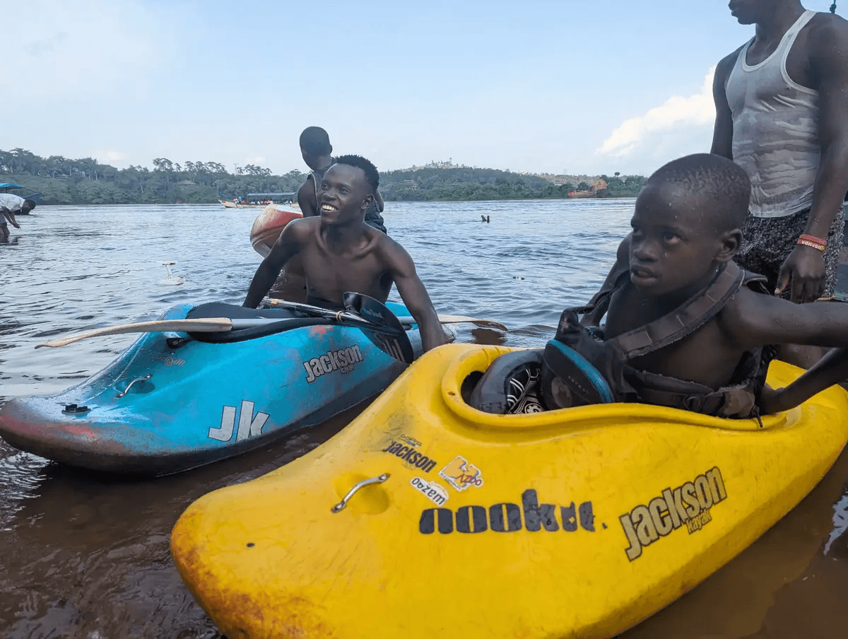 Boys smiling with kayaks