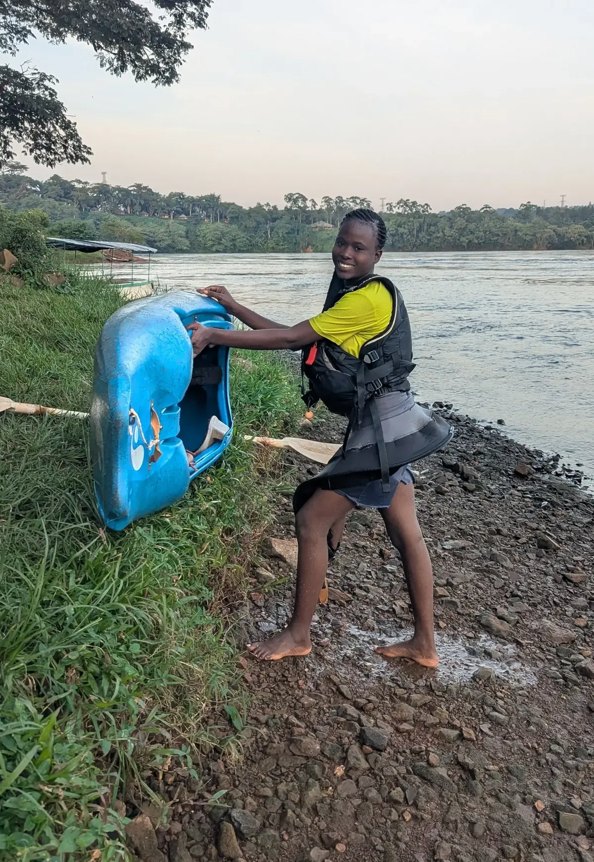 Young girl carrying kayak